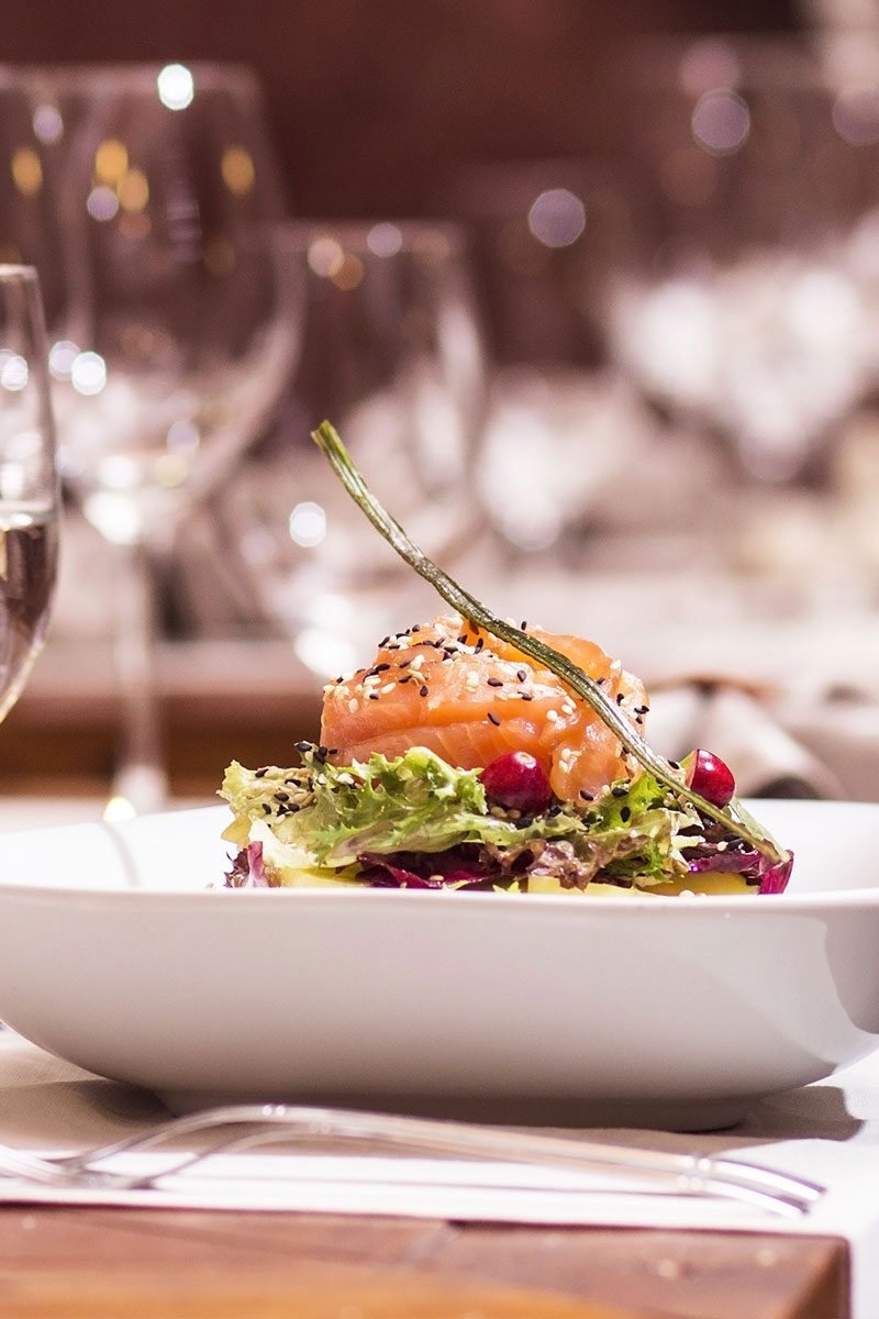 Angerichtetes Fischgericht auf einem gedeckten Tisch im Restaurant Ruiani im Grand Hotel Binz auf Rügen.